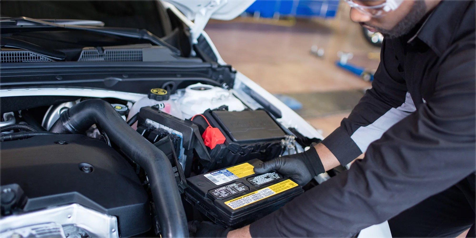 Service Technician installing a car battery